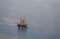 A large sailboat goes to sea under sail. View from above.