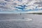 A large sailing frigate, barque or brig sails on a calm sea