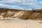 A large sand quarry and a lake. A flooded old abandoned quarry complex. Extraction of sand and stone for industrial applications