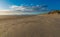 Large sandy beach on a blue sky day