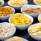 Large savoury snack food selection in porcelain bowls