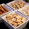 Large savoury snack food selection in porcelain bowls