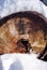 Large sawn poplar tree trunk with hole in center covered with snow, close up