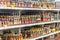 A large selection of alcoholic beverages on the shelves of the supermarket. Text on russian: action, rum, tequila,