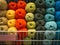a large selection of multi-colored threads for knitting and crocheting on the rack