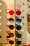 Large selection of sunglasses and glasses on a stand