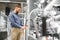 A large selection of water faucets. Man chooses a products in a sanitary ware store