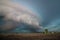 A large shelf cloud and severe thunderstorm approaches fast over farms.