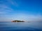 Large ship floating near island with the moon and blue sky