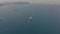 Large ship sailing to open sea, aerial drone front top view video.