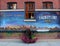 Large sign depicting scenes of history on brick building, Hamilton, New York, 2019