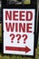Large sign at edge of parking lot directing folks to wine shop