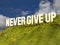 Large sign with phrase NEVER GIVE UP