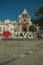 Large signpost with the city name and church