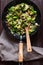 Large skillet with sauteed brussels sprouts and mushrooms, mouth-watering, wood turner