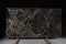 A large slab of dark expensive marble with yellow streaks, called New Portoro