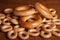 Large and small bagels on wood background