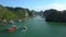 Large and Small Boats Sail in Bay Fjord between Green Islands