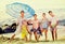 Large smiling family standing together on beach on summer day