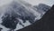 Large snow-capped mountains into which clouds crash