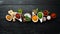 Large spice and herb collection in bowls and spoons. Indian spices. On a black wooden background.