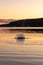 Large splashes from stones tossed into water at sunset