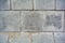 Large square cement street floor slabs. Texture of gray dirty tiles pavement