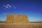 Large stack of hay bales