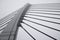 Large steel arch of suspension bridge with metal ropes close up in fog