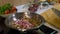 Large steel frying pan with fried mushrooms on an electric stove