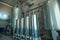 Large steel tanks or vats inside interior of juice and water production plant