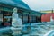 Large stone carved seated Buddha in frozen man made pond