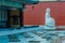 Large stone carved seated Buddha in frozen man made pond