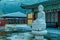 Large stone carved seated Buddha in frozen man made pond