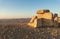 The large  stone dolmen at dawn in a public sculpture park in the desert, on a cliff above the Judean Desert near Mitzpe Ramon in