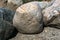 A large stone is lying on the sand