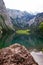 Large stone mountains in the Alps on Obersee Lake with house on shore