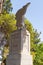 Large stone statue of Elijah - the Prophet stands on a stone pedestal in the garden of the Deir Al-Mukhraqa Carmelite Monastery in