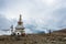 A large stone stupa on the background of cloudy sky and tourist, Nepal.