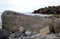 Large stones on the seashore, stone wild beach, seascape in cloudy weather.