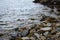 Large stones on the seashore, stone wild beach, seascape in cloudy weather.