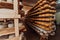 A large storehouse of manufactured cheese standing on the shelves ready to be transported to markets