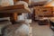 A large storehouse of manufactured cheese standing on the shelves ready to be transported to markets