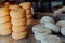 A large storehouse of manufactured cheese standing on the shelves ready to be transported to markets