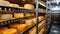 Large storehouse of manufactured cheese standing on the shelves ready to be transported to markets