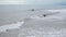 Large storm waves crashing one by one on the long coast of a tropical island