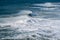 Large surf waves breaking near the beach in Praia do Norte in Nazare, Portugal