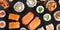 Large sushi set, a close-up panorama, shot from above on a black background