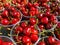 Large sweet cherries poured in transparent plastic cups