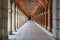 Large symmetrical exterior corridor with arches and columns in the old royal palace of Aranjuez